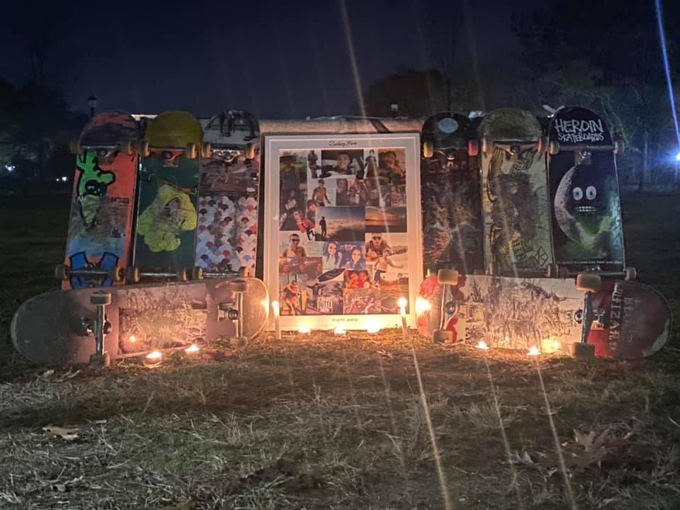 Memorial of skateboards, candles, and photos honoring Zack Forte